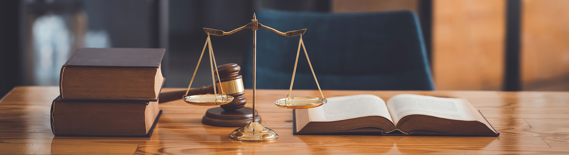 Law books, scales of justice and gavel sitting on desk